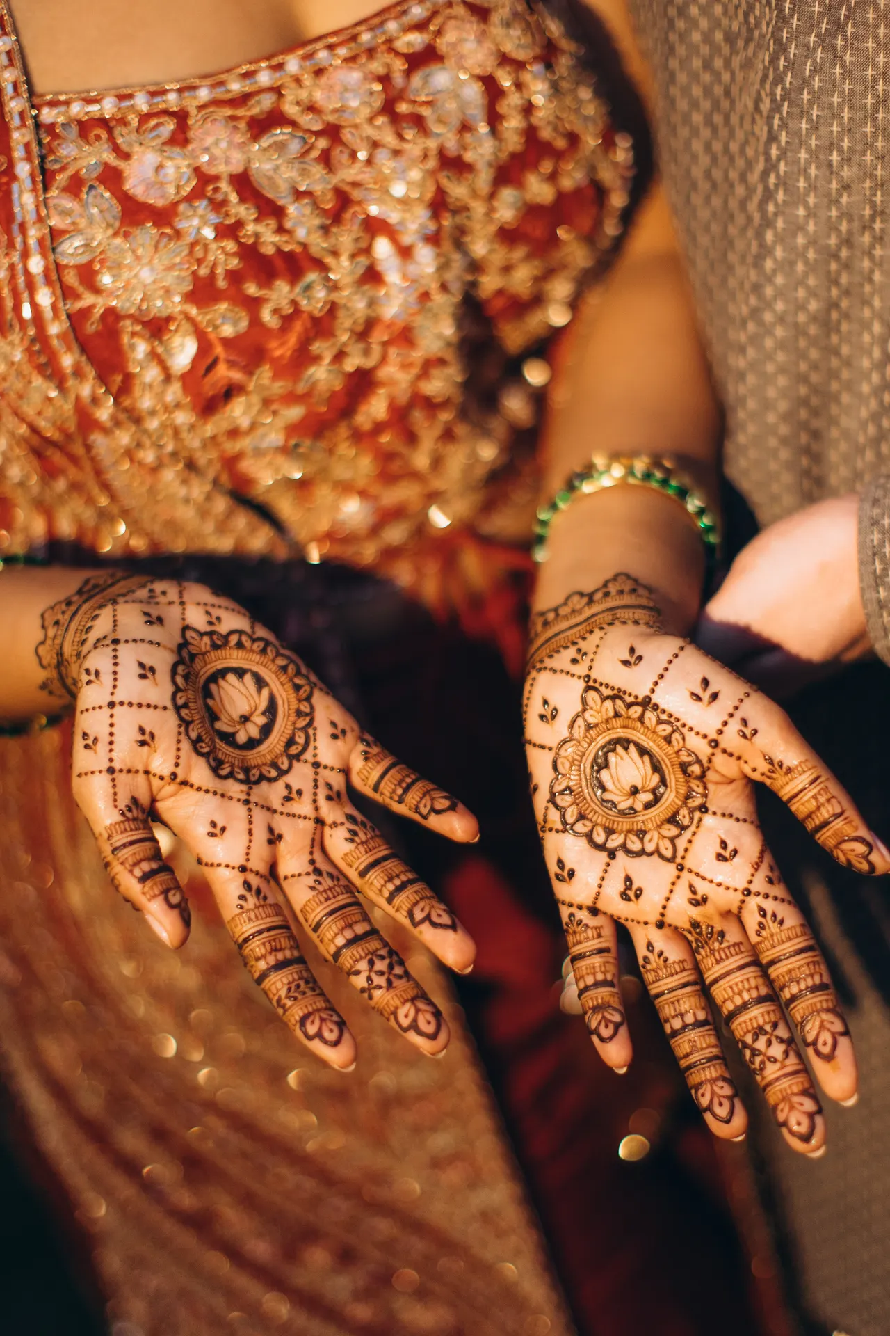 Henna on Sara’s hands, lotus medallions in the palms.